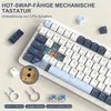 A close-up view of a mechanical keyboard with various accessories laid out around it, including keycaps, switch pullers, and extra switches. Text overlays describe features and included items. Produktbild-Vorschau