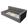 A grey upholstered daybed frame with a slatted base, shown from a three-quarter angle against a white background. Podgląd zdjęcia produktu