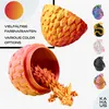 A collage-style marketing image showcasing a 3D printed dragon figurine emerging from an egg, with various color options displayed on the side. Produktbild-Vorschau