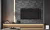 A modern living room with a wall-mounted TV on a textured wall and a media console below. Produktbild-Vorschau