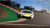 A race car on a track, with trees and a fence in the background. Produktbild-Vorschau