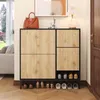 A shoe cabinet with a handbag and lamp on top, placed in a hallway next to a door and a window with a view of trees and a sofa. Podgląd zdjęcia produktu