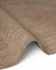A close-up view of a rolled-up jute rug, showing its braided texture and circular pattern. Anteprima dell’immagine prodotto