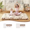 A woman and a child are meditating on a floor mattress in a living room. Náhled obrázku produktu