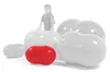 A red and several white peanut-shaped exercise balls are arranged on a white background, with a faint silhouette of a child standing behind the largest white ball. Produktbild-Vorschau