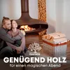 A couple sits by a fireplace with a basket of firewood. Produktbild-Vorschau