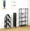 Three black folding shelves are displayed against a white wall with two framed pictures above them. Anteprima dell’immagine prodotto