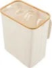 A top-down view of a beige laundry basket with a bamboo rim and three compartments. Produktbild-Vorschau