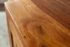 A close-up view of the textured surface of a wooden table. Produktbild-Vorschau