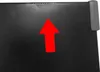 A close-up view of a textured black surface with a red arrow pointing upwards. Produktbild-Vorschau