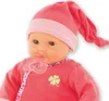 Close-up of a baby doll wearing a pink hat and outfit, with a pacifier. Produktbild-Vorschau