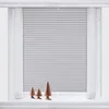 A window with light gray blinds and sheer curtains, decorated with three wooden Christmas trees on the windowsill. Produktbild-Vorschau