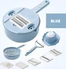 A collection of blue kitchen utensils, including a multi-functional vegetable cutter, peeler, colander, and various blades, arranged on a white and light blue background. Náhľad obrázku produktu