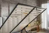 Close-up view of an open bed frame with wooden slats, showing the internal storage mechanism. Produktbild-Vorschau