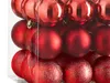 A close-up view of several red Christmas ornaments in a clear plastic package. Anteprima dell’immagine prodotto