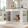A kitchen island with integrated dog bed and storage, set in a bright, modern kitchen with large windows. Anteprima dell’immagine prodotto