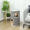 Two kittens playing in a cat tree next to a sofa and a plant stand. Produktbild-Vorschau