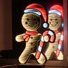 A lit-up gingerbread man decoration with a candy cane, reflected in a mirror. Produktbild-Vorschau