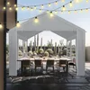 A white party tent set up outdoors with a dining table and chairs, surrounded by various types of cacti. Produktbild-Vorschau