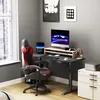 A gaming setup in a room with a desk, chair, and computer. Náhled obrázku produktu