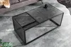 A modern coffee table with a marble-like top and a metal frame, placed on a concrete floor next to a sofa. Produktbild-Vorschau