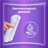 A hand is shown pointing to a sanitary pad, with a graphic indicating dermatological testing and skin-friendliness. Produktbild-Vorschau