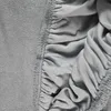 A close-up view of a gray fitted sheet, showing the texture of the fabric and the elasticized edge. Náhled obrázku produktu