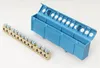 A brass terminal block with screws and a blue plastic housing for a DIN rail are shown on a white background. Produktbild-Vorschau