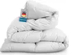 A folded white duvet is stacked on top of itself, with a tag attached to the top duvet. Produktbild-Vorschau