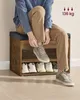 A person sitting on a shoe bench and tying their shoes. Náhled obrázku produktu