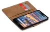 A brown book-style case for a smartphone, with two cards inserted into a slot. Anteprima dell’immagine prodotto