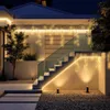Outdoor staircase and walkway illuminated by string lights at night. Náhled obrázku produktu