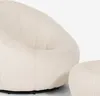 Close-up of a white bouclé armchair and ottoman. Produktbild-Vorschau
