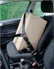 A cardboard box secured with a seatbelt on a car seat. Anteprima dell’immagine prodotto