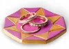 Three rings are displayed on a pink and gold octagonal dish. Produktbild-Vorschau