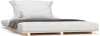 A white mattress with pillows and a gray throw blanket on a wooden slatted bed frame. Produktbild-Vorschau