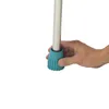 A hand is holding the teal rubber foot of a metal pole, likely a table tennis table leg. Produktbild-Vorschau