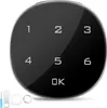 A digital keypad lock with numbers 1-6 and an OK button, shown on a black reflective surface. Accessories are visible in the bottom left corner. Produktbild-Vorschau
