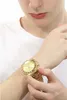 A person wearing a gold watch. Podgląd zdjęcia produktu