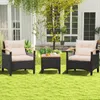 A patio furniture set consisting of two chairs and a table is placed on a green lawn in front of a house. Voir les images du produit