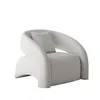 A white, textured armchair with a small grey pillow sits against a white background. Anteprima dell’immagine prodotto