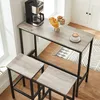 A bar table and two stools are set up in a kitchen or dining area, with a coffee maker and pastries on the table. Produktbild-Vorschau
