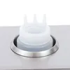 A close-up of a sauce bottle with a multi-spout cap, placed in a stainless steel holder on a stainless steel surface. Náhled obrázku produktu