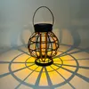 A solar-powered lantern casting a patterned shadow. Produktbild-Vorschau