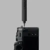 A close-up shot of an electric screwdriver being used to tighten a screw on a camera. Náhled obrázku produktu