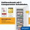 A white upright freezer with its door open, showing multiple transparent drawers filled with food items. There are also marketing badges and an energy efficiency label visible. Produktbild-Vorschau