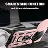 A close-up shot of a rose gold smartphone case with a ring holder, placed on a textured surface with a blurred background of electronic devices. Produktbild-Vorschau
