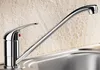 A close-up shot of a modern chrome kitchen faucet over a sink, with a textured beige backsplash in the background. Produktbild-Vorschau