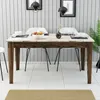 A dining table set up for a meal in a modern dining room. Produktbild-Vorschau