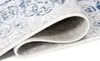 A close-up view of a rolled-up rug, showing the texture and pattern of the fabric. Produktbild-Vorschau